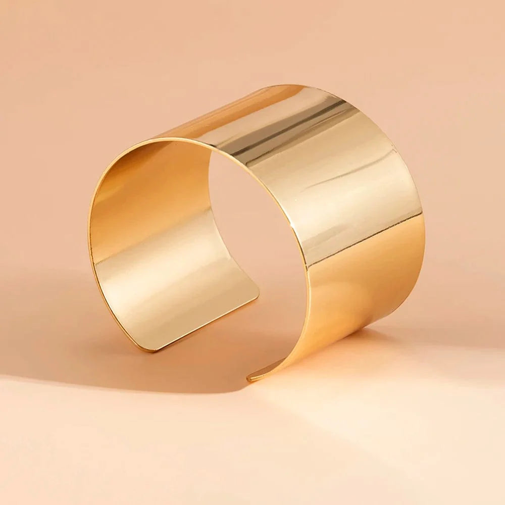 Gold-colored wide cuff bracelet with a smooth finish, open design, punk style, perfect for women’s fashion and jewelry accessories.