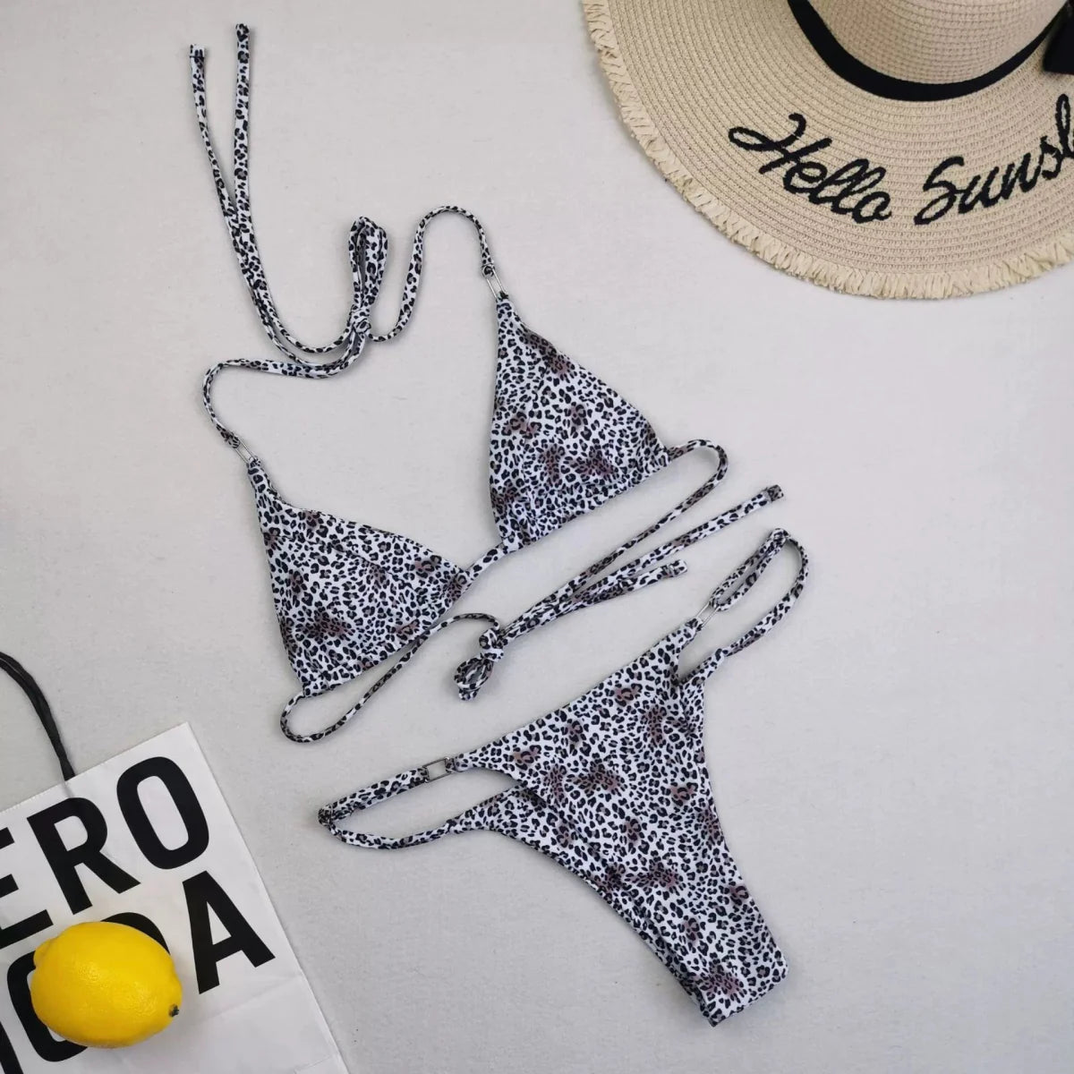 Leopard print lace-up bikini top with triangle cups and high-cut bottoms, stylish swimwear by Showlu Fashion Store.
