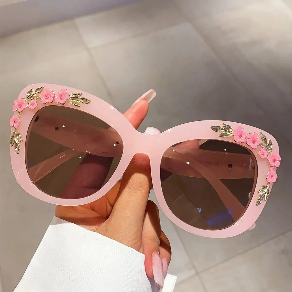 Buyuteen Women's Oversized Cat Eye Sunglasses with pink UV400 lenses, vintage floral design, trendy big frame, and stylish punk-inspired look.