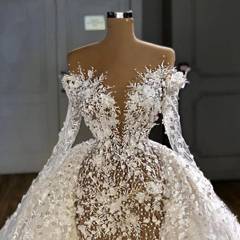 Elegant white A-line wedding dress with long sleeves and beaded organza fabric, featuring a sweeping train for bridal elegance.