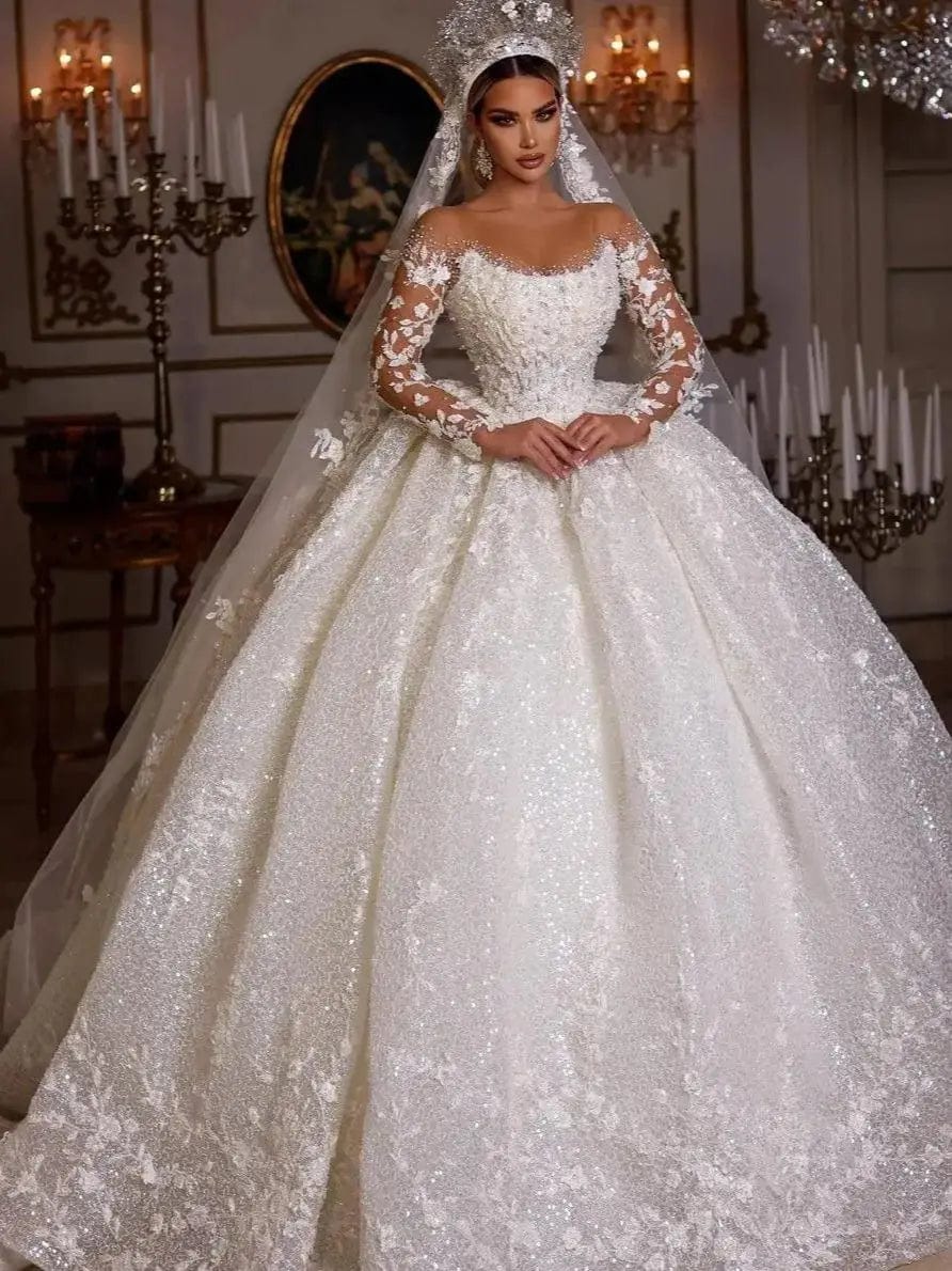 Vinca Sunny lace ball gown wedding dress by Showlu Fashion with long sleeves, tulle fabric, sequins, beads, and sheer neckline.