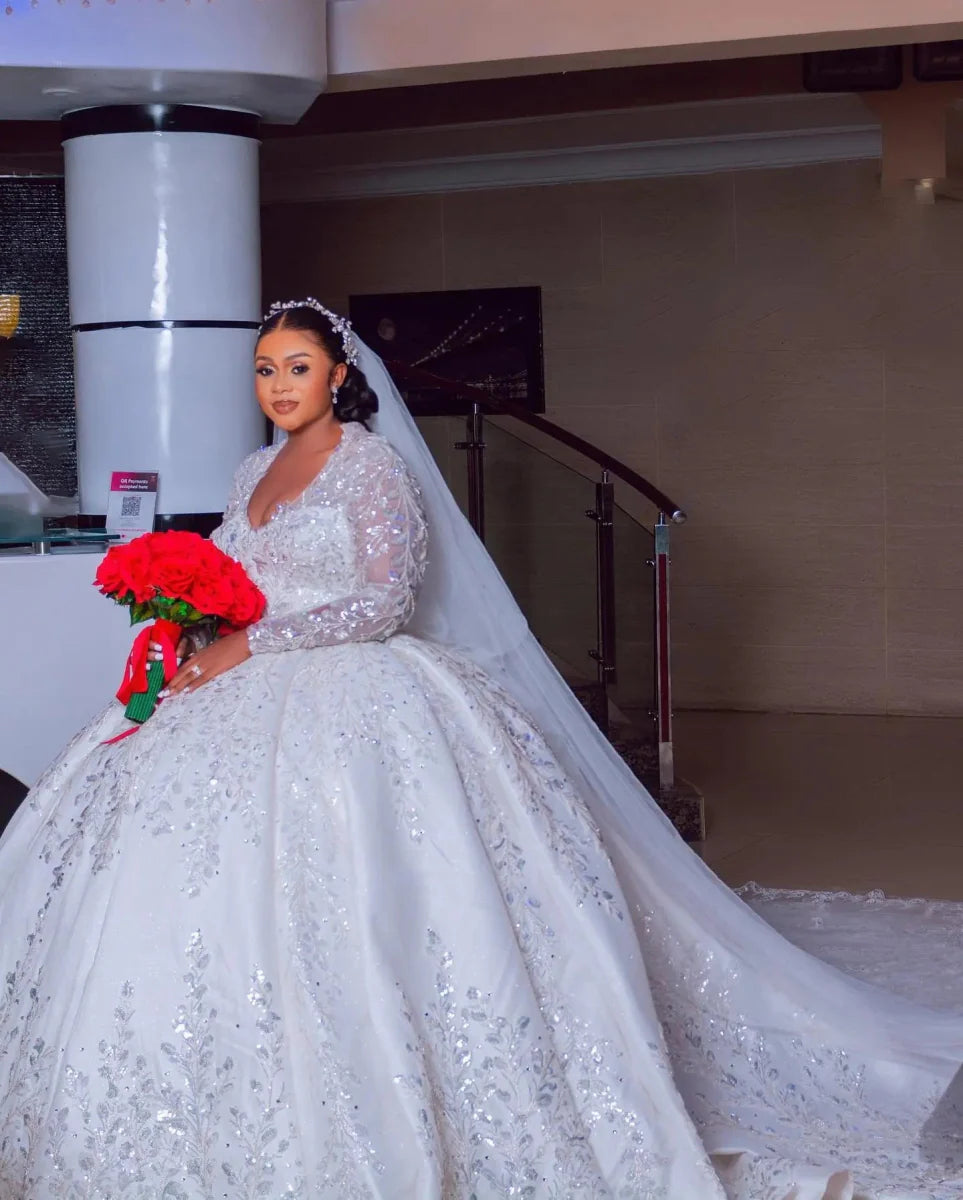 Vinca Sunny luxury ball gown wedding dress by Showlu Fashion with lace, long sleeves, satin fabric, and beaded details for plus size brides