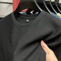 Showlu men's wrinkle-resistant short sleeve T-shirt with round neck, breathable fabric, and versatile summer style.
