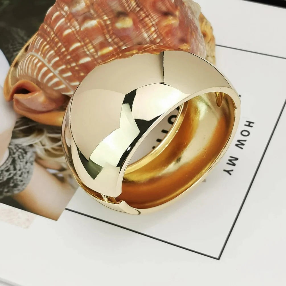 Wide gold alloy cuff bangle for women, statement punk jewelry with shiny surface and bold design by Showlu Fashion.