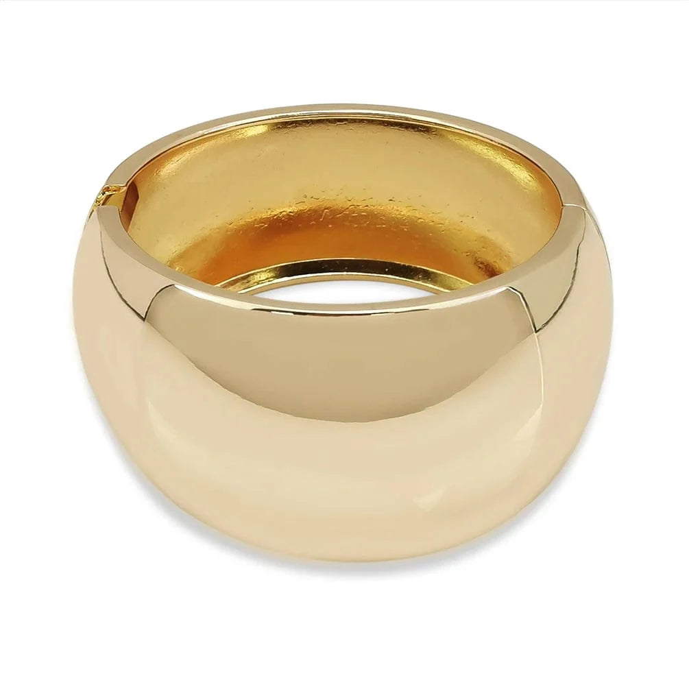 Wide gold alloy cuff bracelet for women, stylish statement punk jewelry bangle with shiny surface and bold design.