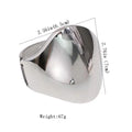 Shiny alloy cuff bangle with geometric design, featuring a bold punk style, worn on a woman's wrist for a statement jewelry look.