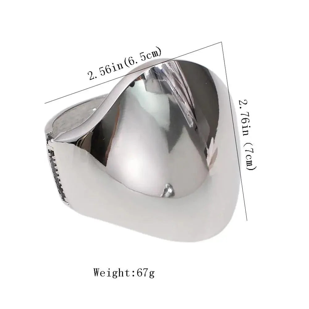 Shiny alloy cuff bangle with geometric design, bold statement bracelet for women, showing its polished surface and modern style.