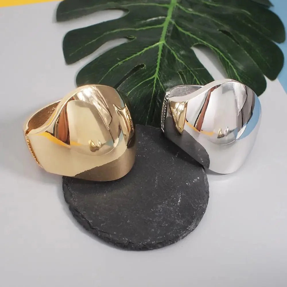 Shiny alloy cuff bangle with geometric design, statement jewelry for women, featuring a bold, modern bracelet style.