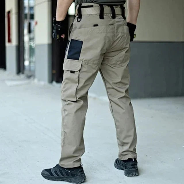 Men's SHOWLU tactical cargo shorts in waterproof camo ripstop fabric, with multiple pockets for outdoor hiking and summer activities.