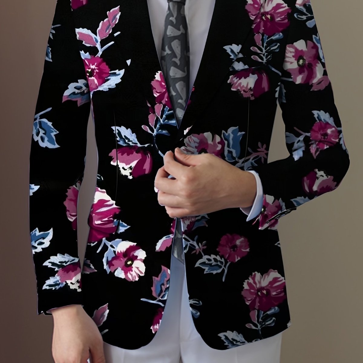 Men's navy blue floral print blazer with two buttons, vibrant red, white, and blue flowers, tailored for casual or formal wear.