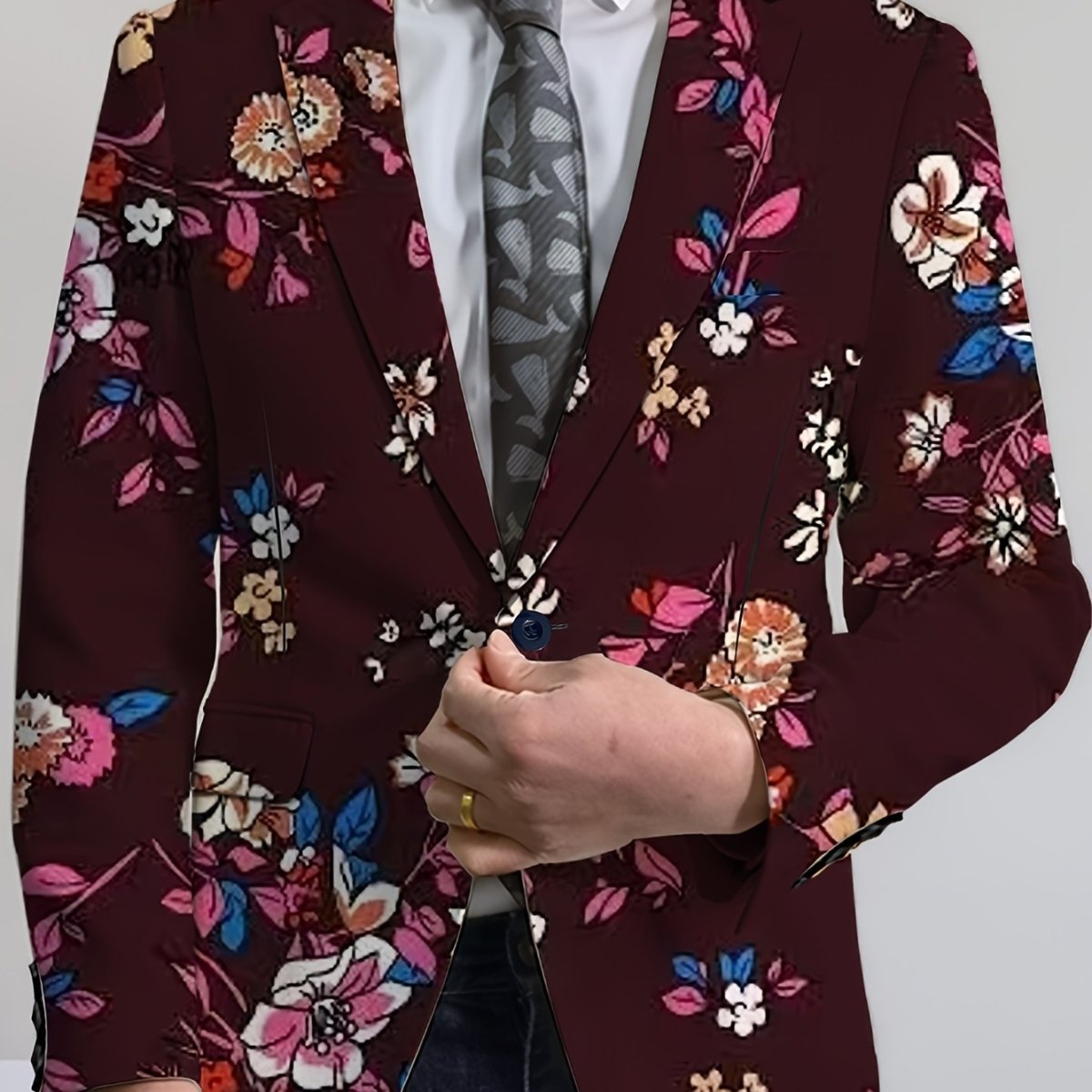Men's navy blue floral print blazer with two buttons, featuring vibrant red and white flower patterns, suitable for casual or formal wear.