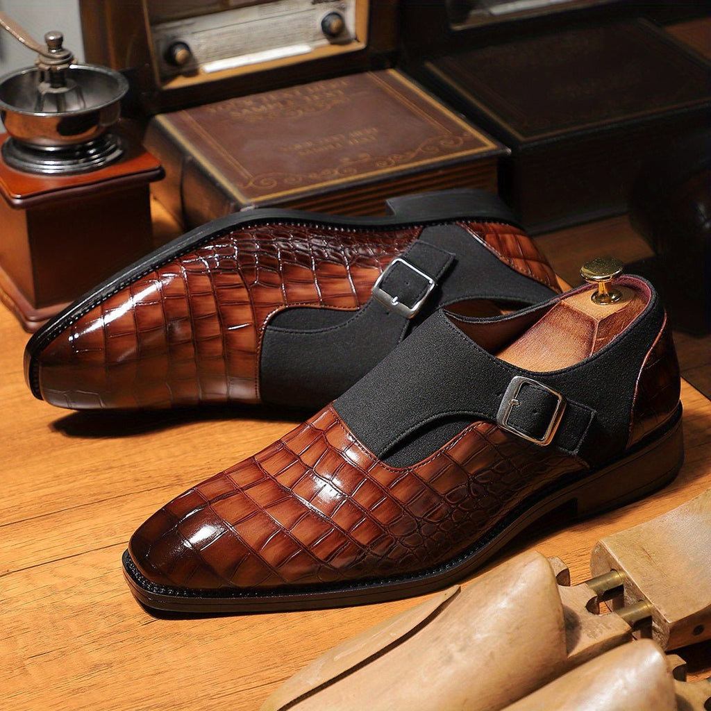 Men's navy blue monk strap shoes with crocodile pattern, pointed toe, adjustable buckle, slip-on style, suitable for formal occasions.
