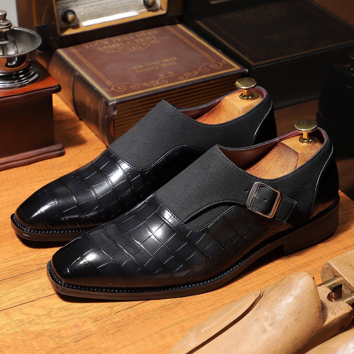 Men's navy blue monk strap shoes with pointed toe and crocodile pattern, featuring adjustable buckle straps and slip-resistant soles.