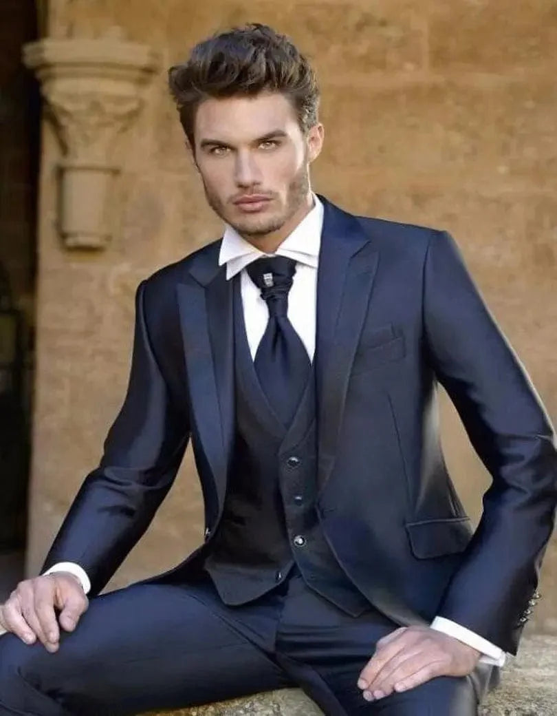 Men's white satin tuxedo with slim fit, three-piece design including blazer, vest, and pants for wedding or formal occasions.