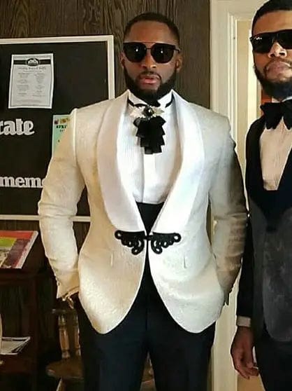 Black men's Italian design 3-piece wedding tuxedo suit with skinny fit, jacket, vest, and pants, worn by a groom at a wedding.