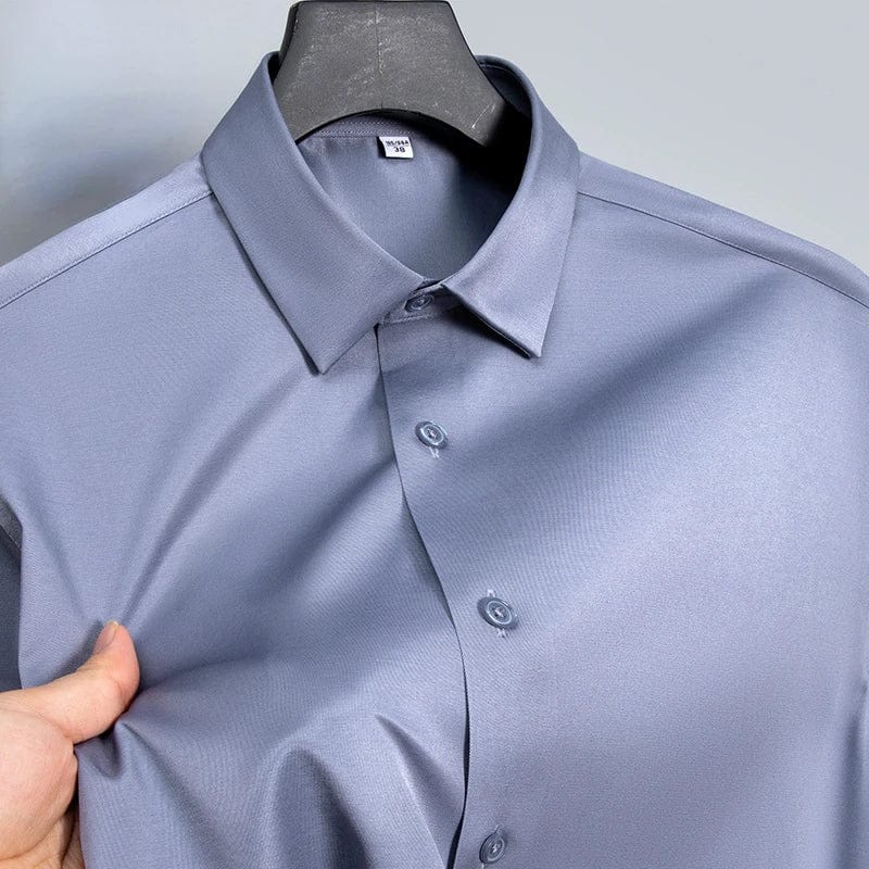 SHOWLU Men's slim fit long sleeve work shirt in micro elastic broadcloth, available in white, black, and blue for casual or formal wear.