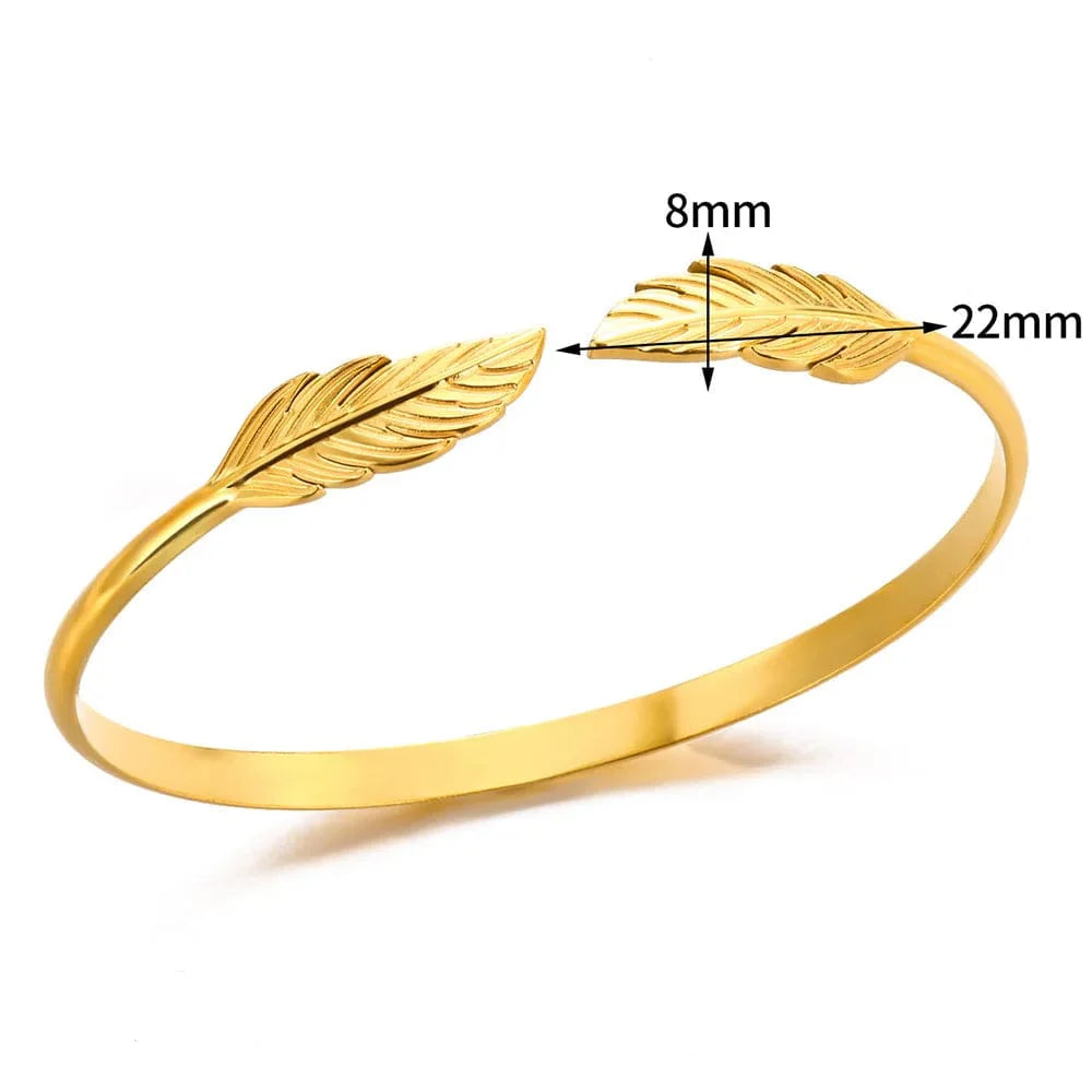 Minimalist stainless steel cuff bracelet in vintage gold color, designed for women, with textured charm details for daily wear.