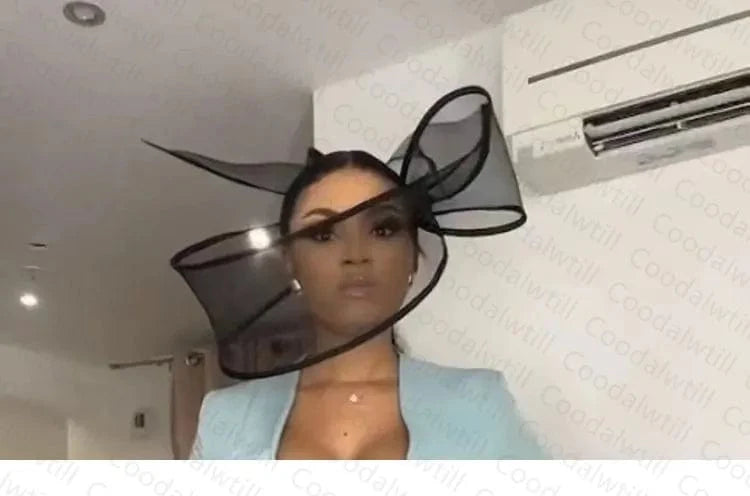Elegant black Showlu pillbox hat with fascinator design, perfect for wedding or formal events, featuring a stylish hair clip.