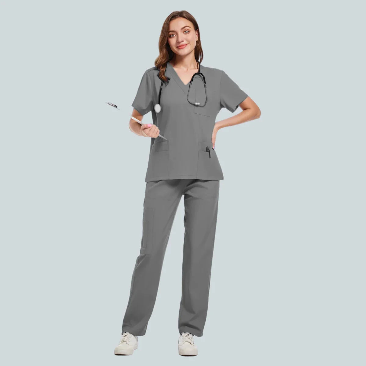 Unisex medical scrub set with sweatshirt and pants, polyester spandex fabric, worn by a nurse in a hospital setting.