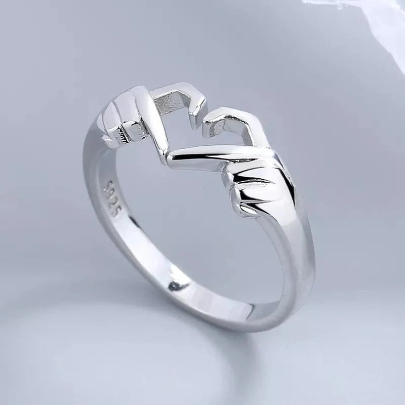 Silver adjustable heart-shaped hand ring for couples, romantic jewelry piece with creative design, perfect for gifts or special occasions.