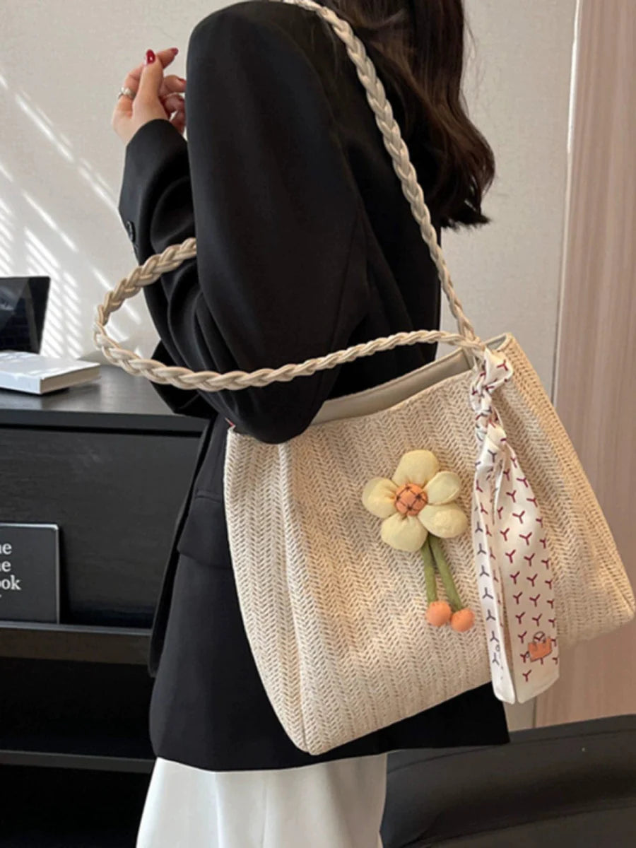 Large woven straw bucket bag with shoulder strap, spacious summer tote designed for women, perfect for vacations and everyday use.