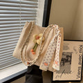 Large capacity Soo Cat woven straw bucket bag with shoulder strap, perfect for summer vacations and casual outings.