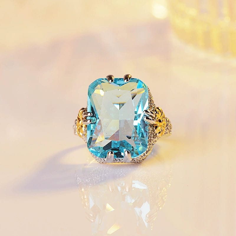 Showlu Ocean Blue Princess Ring with gold flower design and sterling silver inlay, stylish women's jewelry.