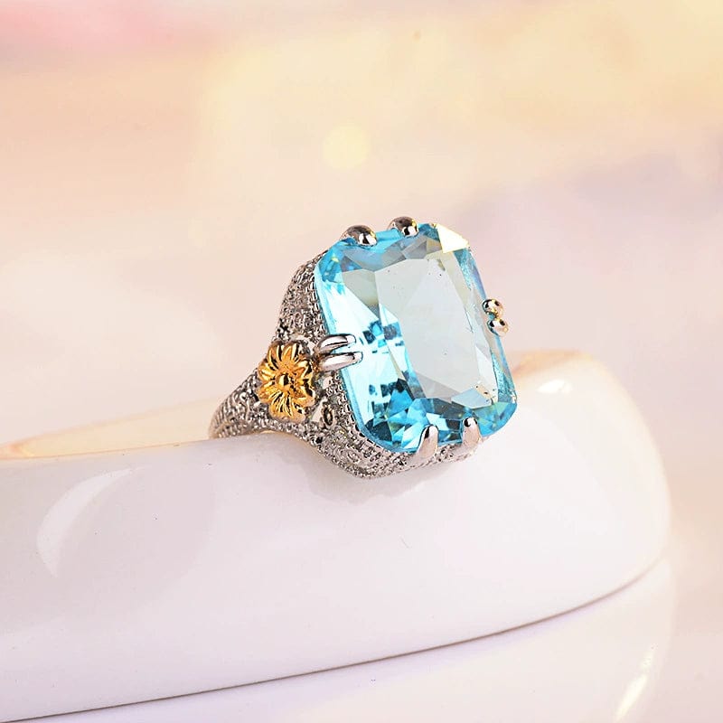 Ocean blue princess ring by Showlu Fashion with gold flower design, sterling silver inlay, and European-American style.