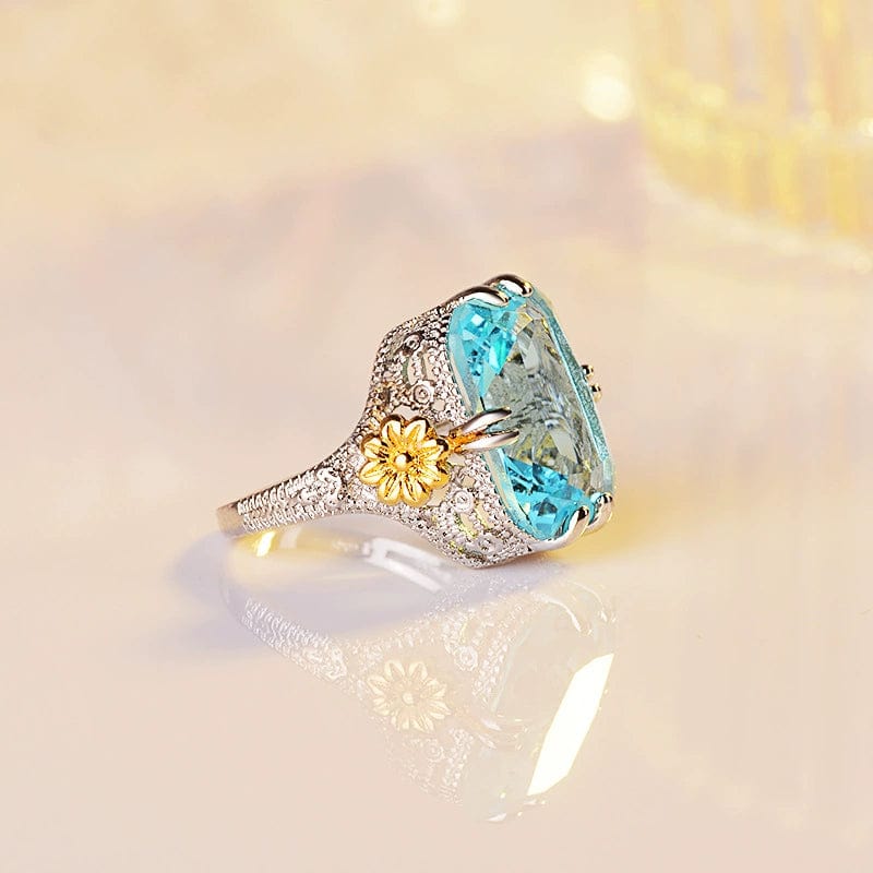 Ocean blue princess ring by Showlu Fashion featuring gold flower design and sterling silver inlay, stylish women's jewelry.