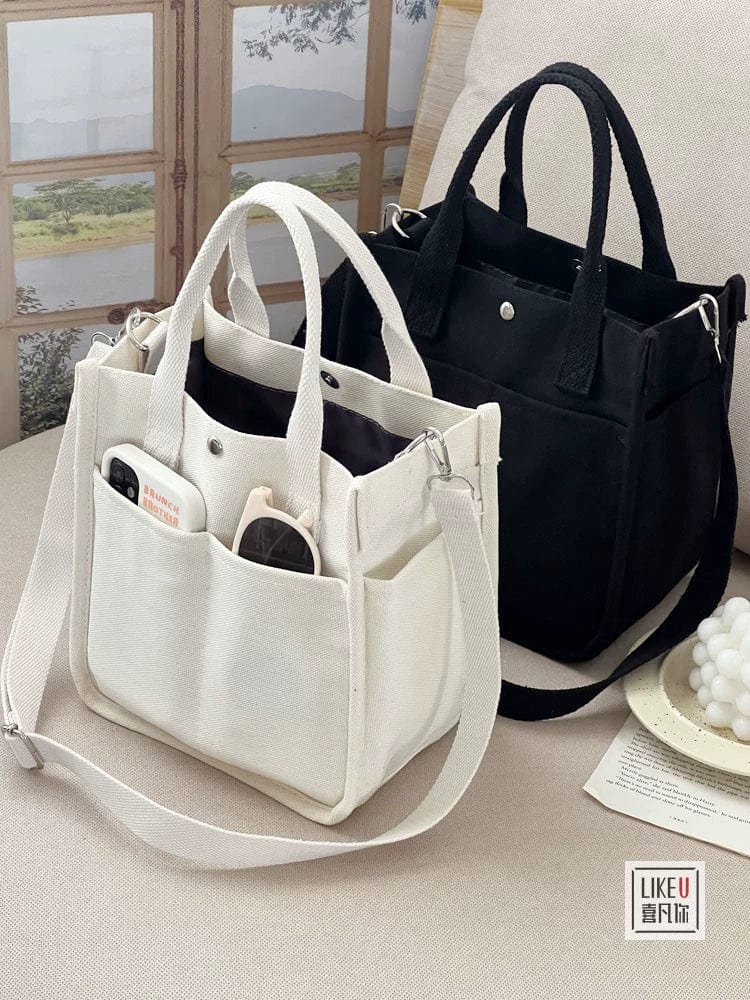 Showlu Fashion Hefan You multi-pocket canvas tote bag with a vertical square design, featuring multiple compartments and a crossbody style.