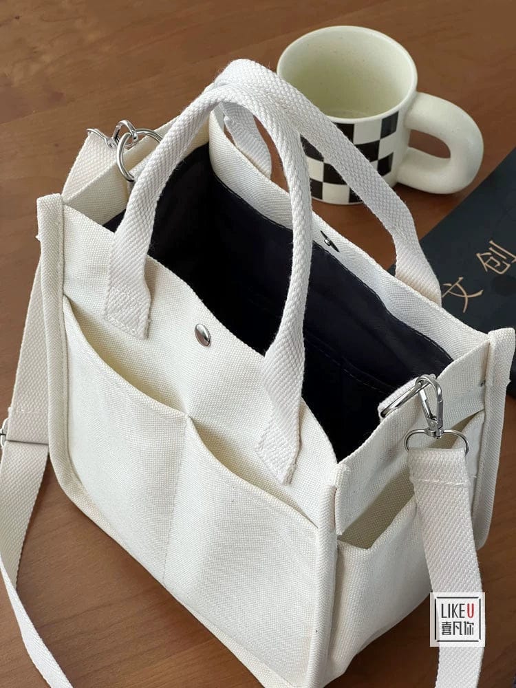 Showlu Fashion Store Hefan You multi-pocket canvas tote bag with vertical square design, featuring multiple compartments and a crossbody style.