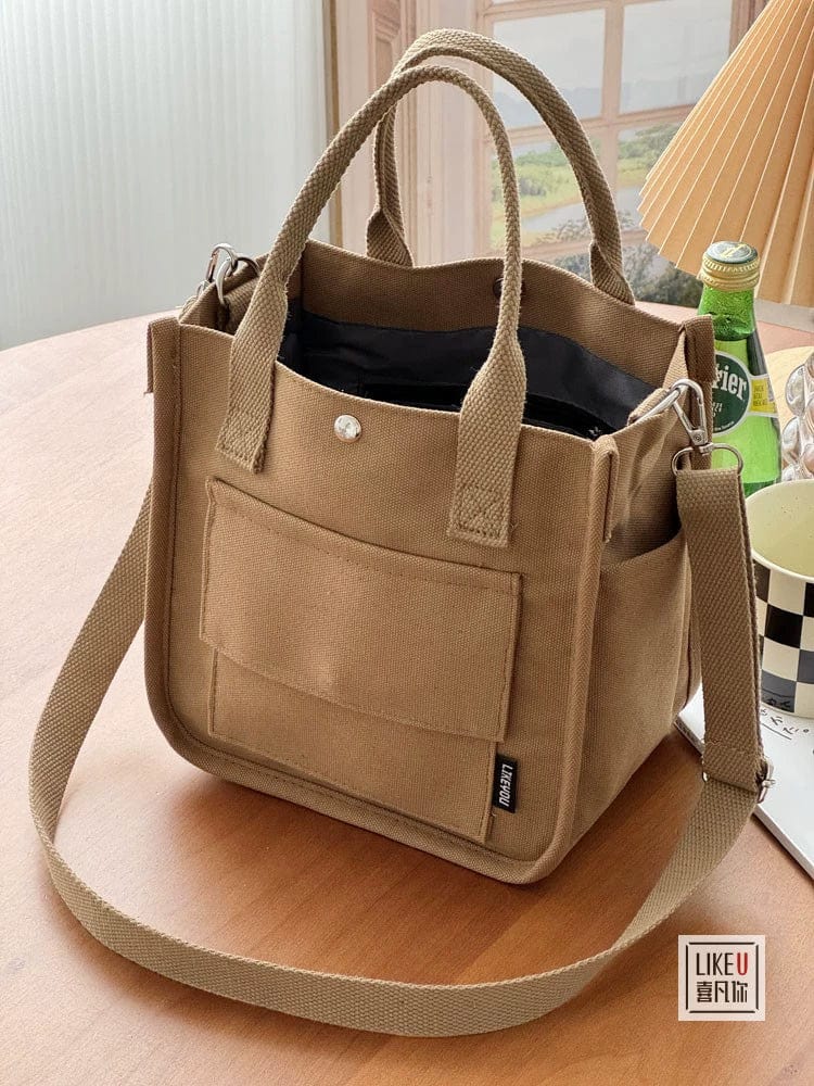 Hefan You multi-pocket canvas tote bag with vertical square design and crossbody strap, showing multiple compartments and stylish structure.