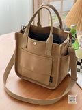Hefan You multi-pocket canvas tote bag with vertical square design and crossbody strap, showing multiple compartments and stylish structure.