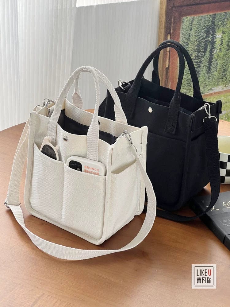 Showlu Fashion Hefan You multi-pocket canvas tote bag with vertical square design, featuring multiple functional compartments and a crossbody style.