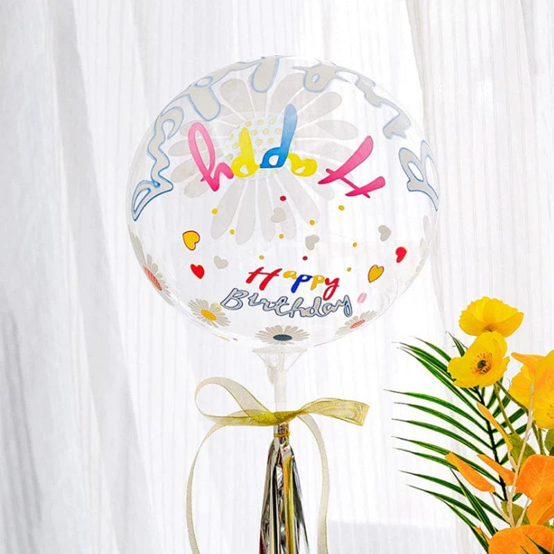 Transparent birthday bounce ball with cartoon print, featuring colorful fonts and heart designs, ideal for festive party decor.