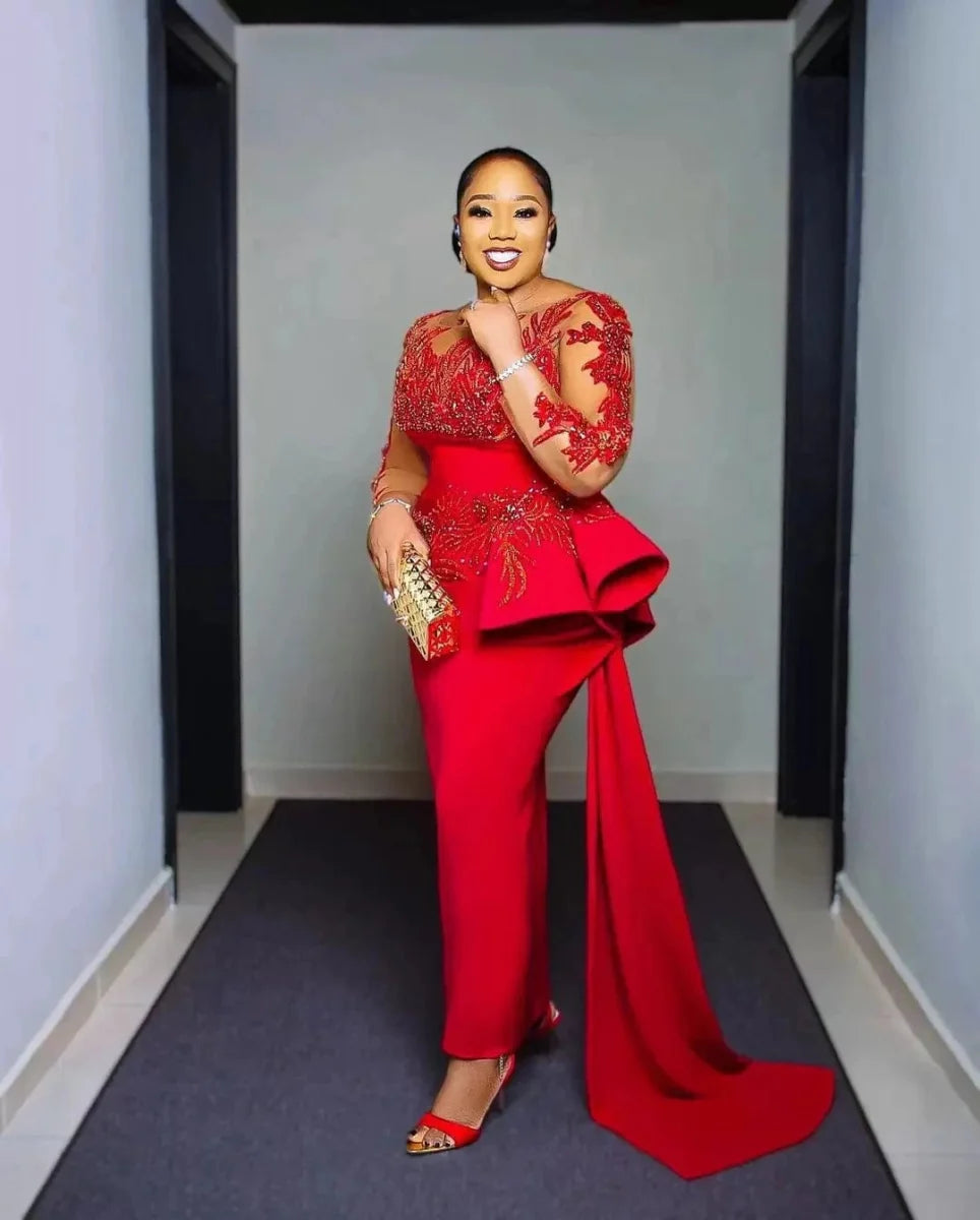 Plus-size red lace Arabic Aso Ebi prom dress with sheer long sleeves, appliques, sheath silhouette, and sweep train for elegant evening events.