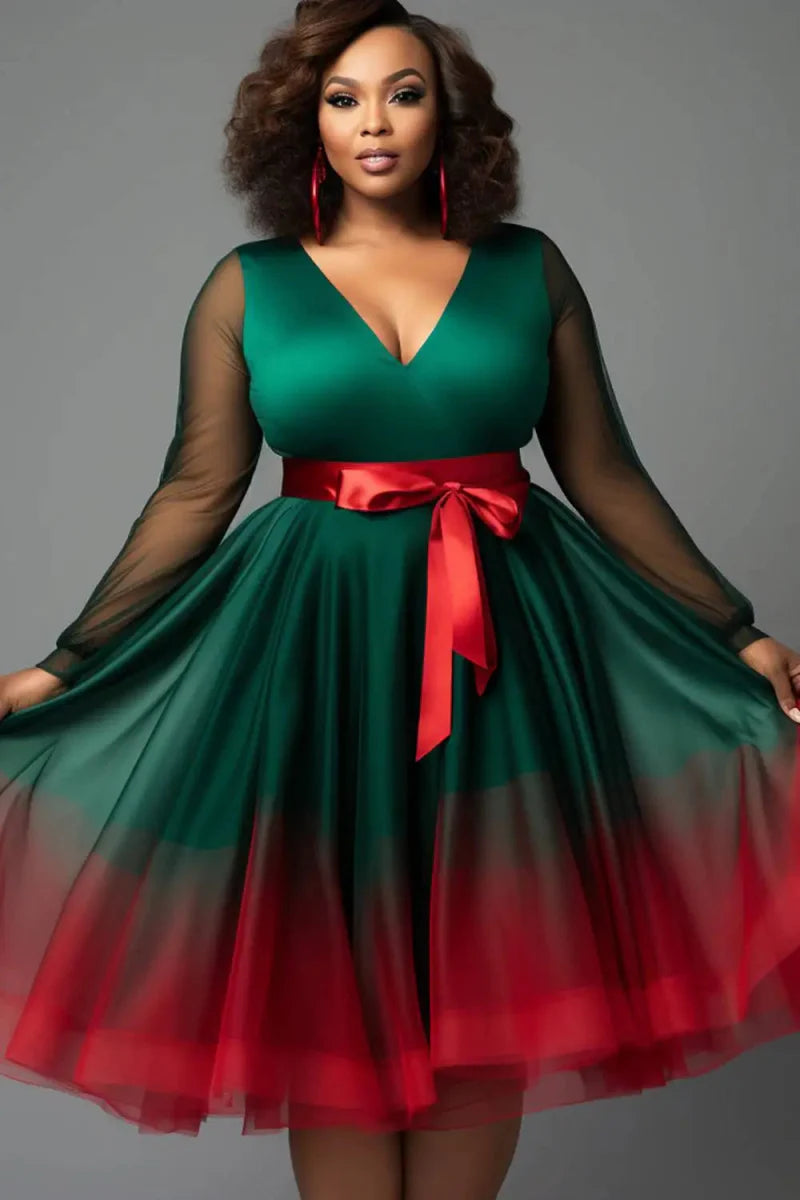Plus-size emerald green V-neck tulle mini wrap dress with lantern sleeves and see-through details, designed by Showlu Fashion.