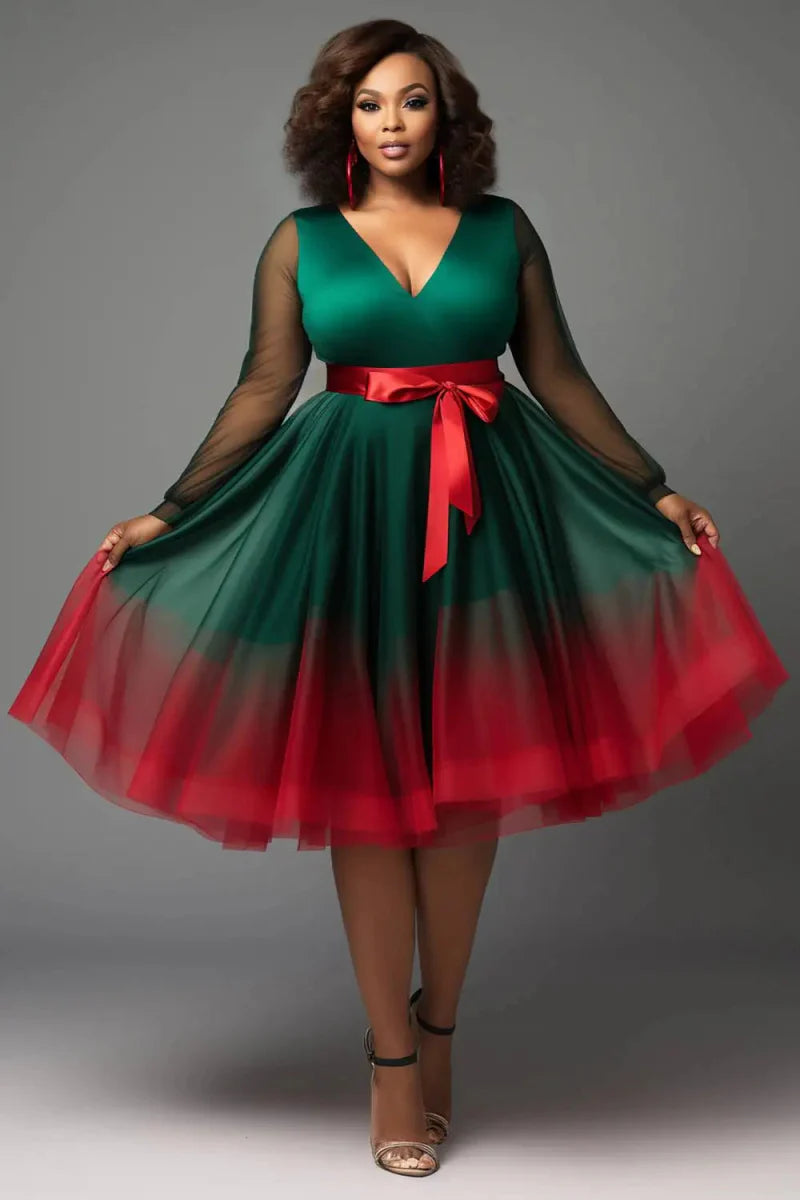 Plus-size emerald green V-neck tulle mini wrap dress with lantern long sleeves and see-through details by Showlu Fashion.