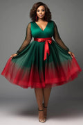 Plus-size emerald green V-neck tulle mini wrap dress with lantern long sleeves and see-through details by Showlu Fashion.
