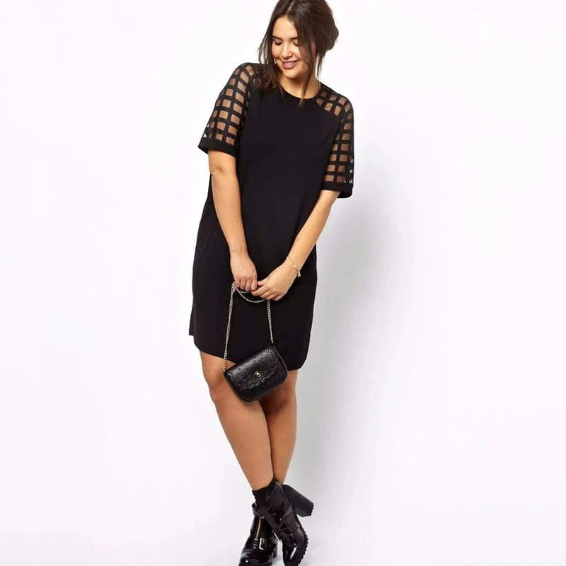 Plus size Showlu mesh panel slimming dress with knee-length design and belly covering feature.