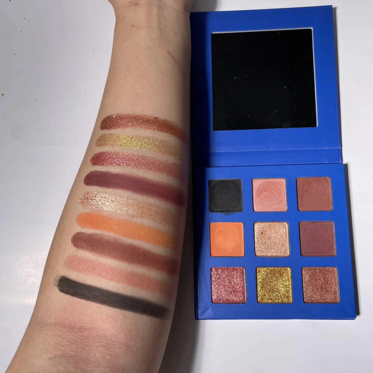 Showlu 9-color eyeshadow palette with high-pigment matte and shimmer shades, featuring a minimalist cardboard packaging.