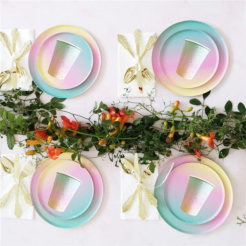 Showlu Rainbow Birthday Party Tableware Set with colorful paper plates, napkins, cups, and tablecloth for celebration decorations.