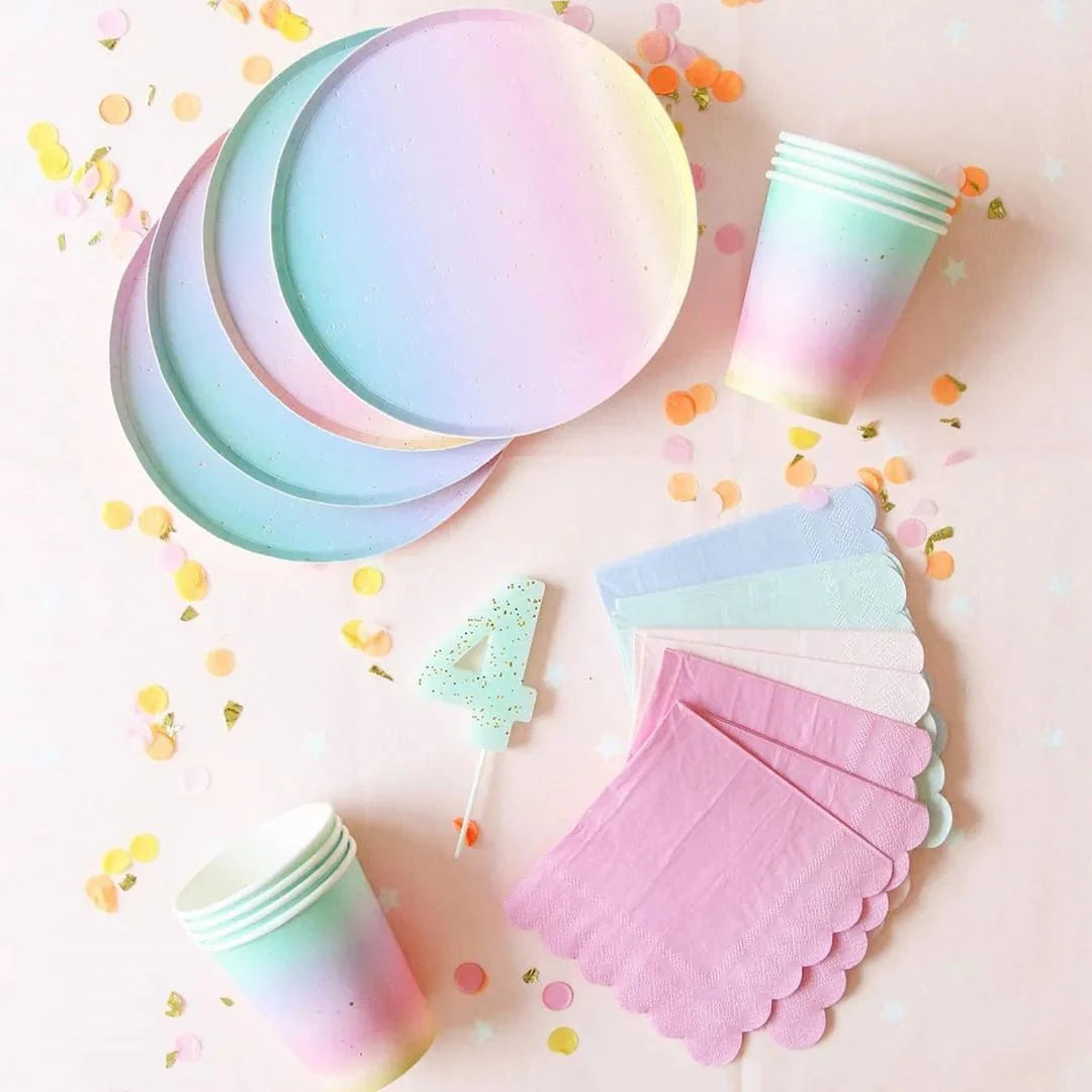 Rainbow birthday party tableware set with colorful paper plates, napkins, cups, and tablecloth for festive celebrations.