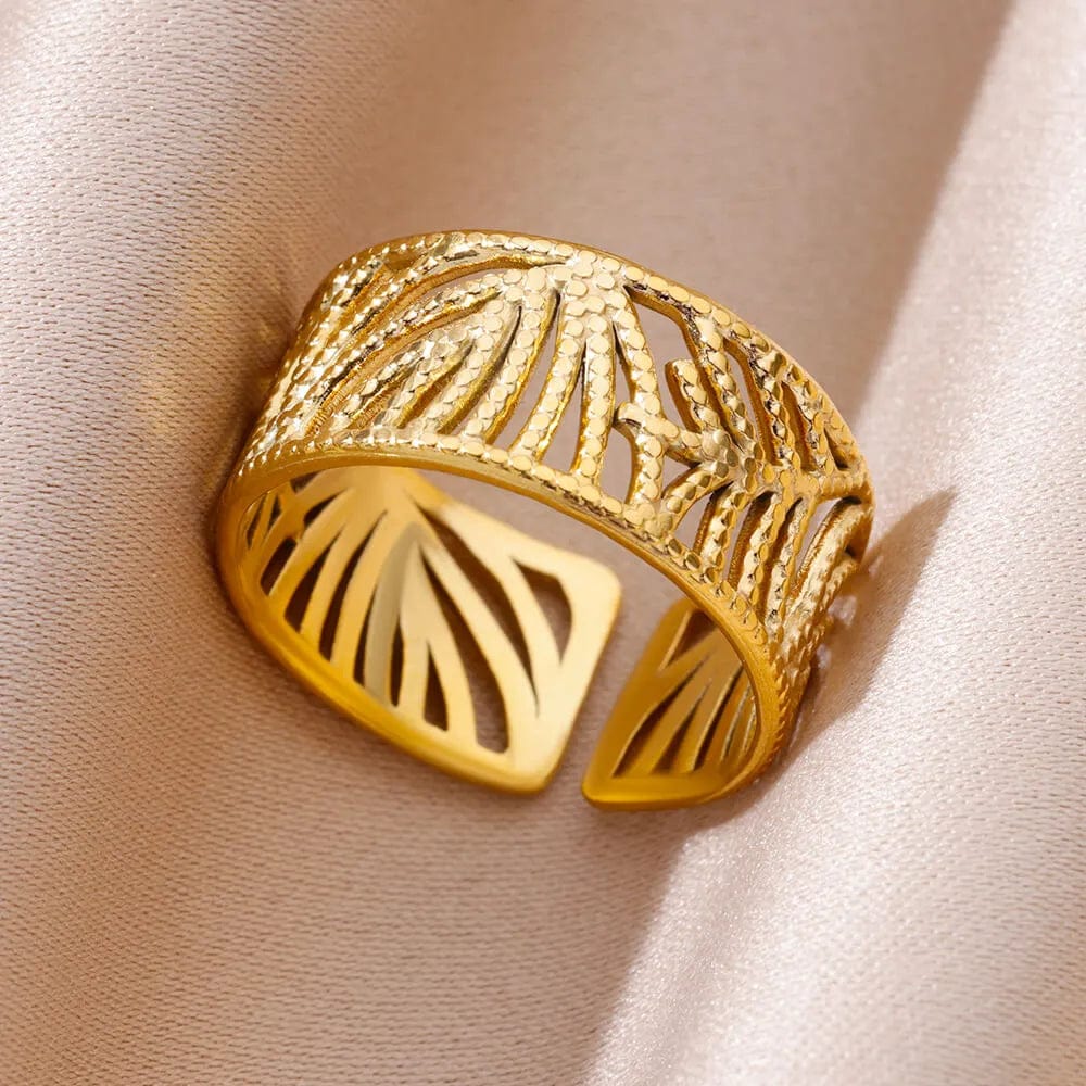 Showlu Women's vintage gold stainless steel angel feather ring on a woman's finger, featuring intricate feather design and elegant style.
