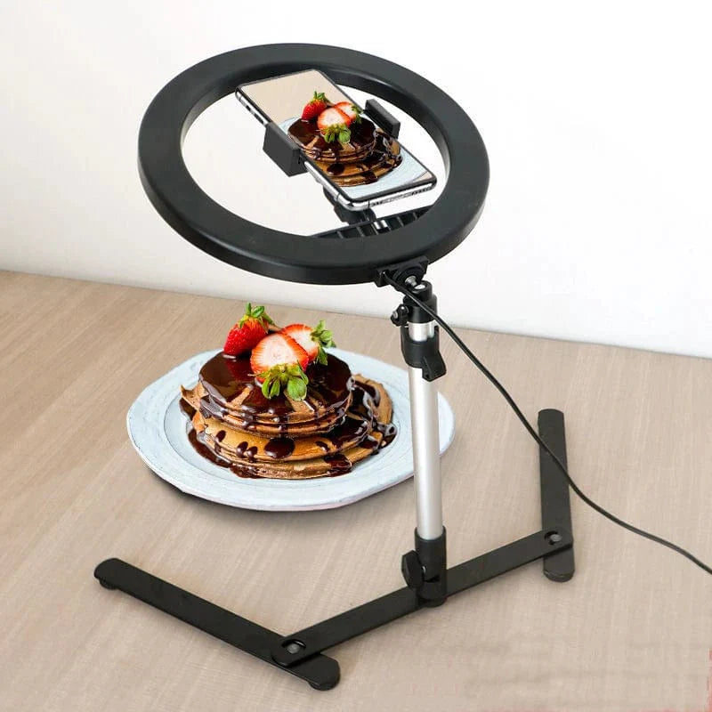 Showlu Fashion 10-inch LED ring light on tripod stand, ideal for phone photography and selfie lighting with bright, even illumination.