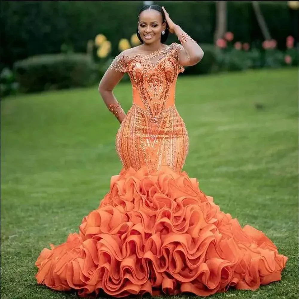 Romantic orange mermaid evening dress with lace, ruffles, bead embellishments, suitable for formal occasions and parties.