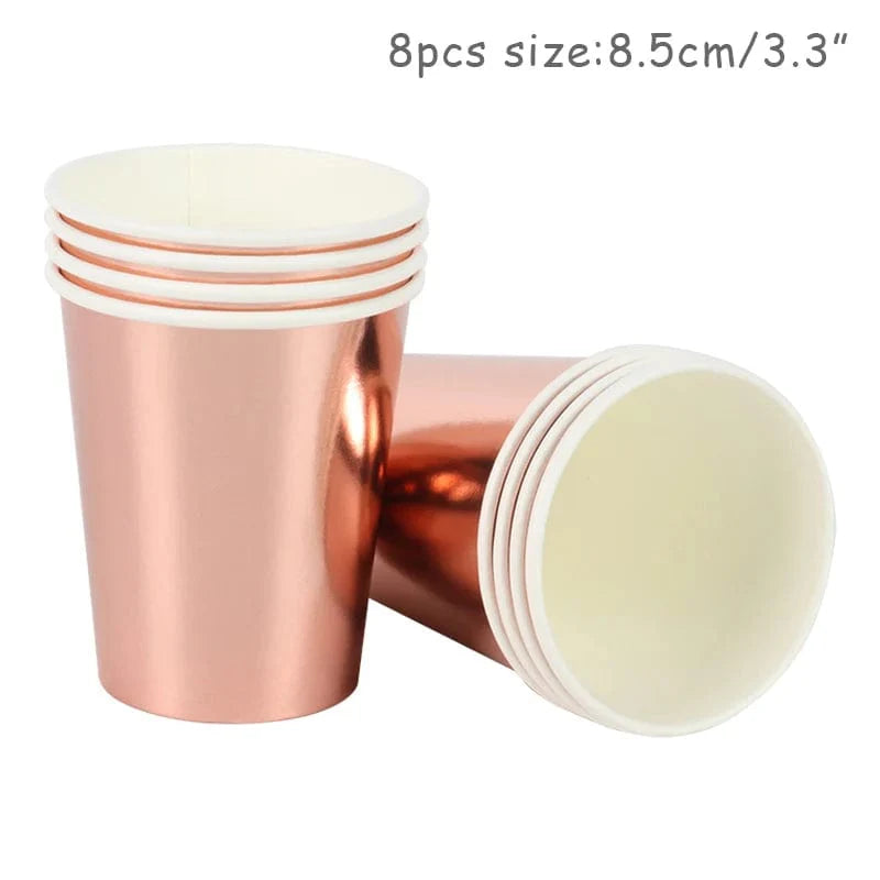 Rose gold disposable tableware set with paper plates, cups, napkins, and tablecloth for birthday and wedding celebrations.