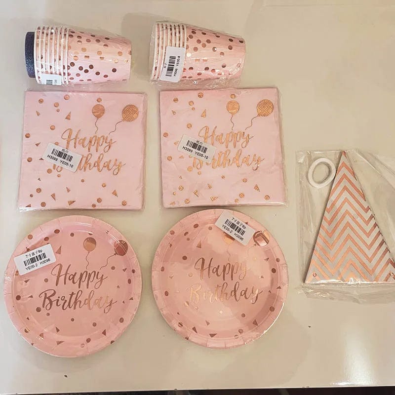 Rose gold disposable tableware set with paper plates, cups, and napkins for birthday or wedding party decorations.