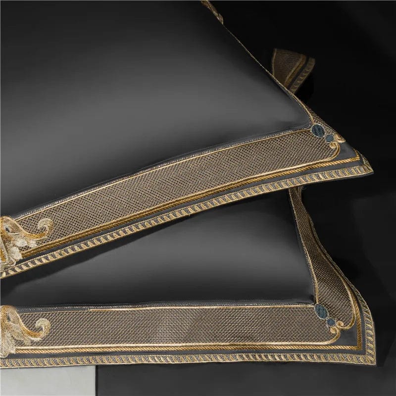 Luxury satin Egyptian cotton bedding set with gold embroidery, includes duvet cover, flat and fitted sheets, and pillowcases.