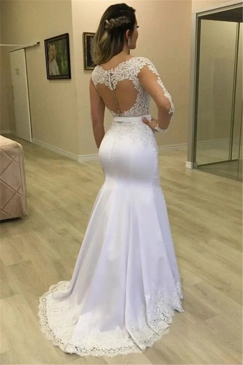 Sheer long sleeve mermaid wedding dress with a see-through back and detachable train, featuring a custom two-piece design.